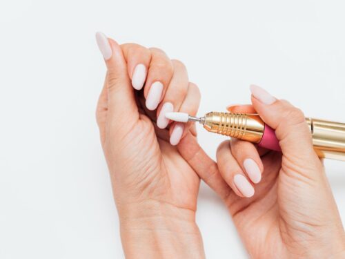 Woman using digital nail file